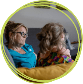 Girl with care team member in lounge